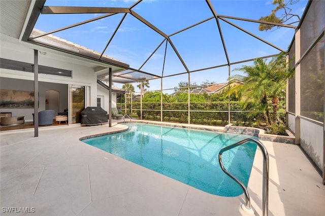 pool featuring a grill, a lanai, and a patio area