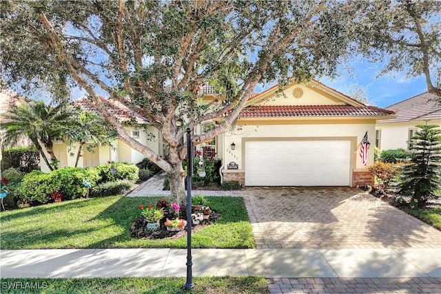 view of front of home with a garage and a front lawn