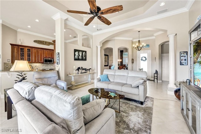 living room with ornamental molding, a healthy amount of sunlight, and ornate columns