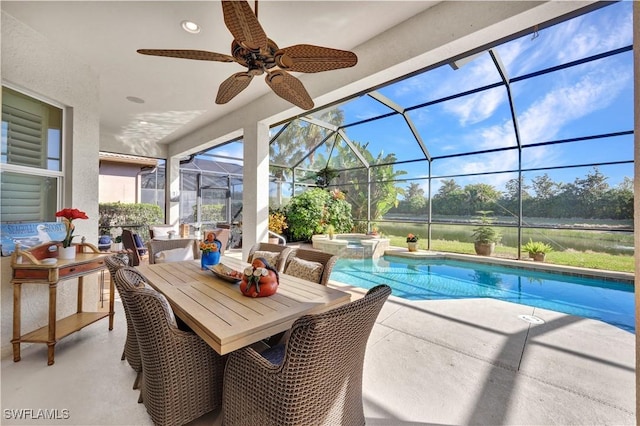 view of swimming pool with an in ground hot tub, ceiling fan, a patio area, and glass enclosure