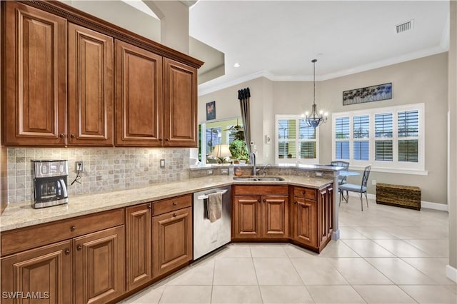 kitchen featuring dishwasher, sink, backsplash, a chandelier, and light stone counters