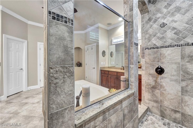 bathroom featuring crown molding, tiled shower, vanity, and a towering ceiling