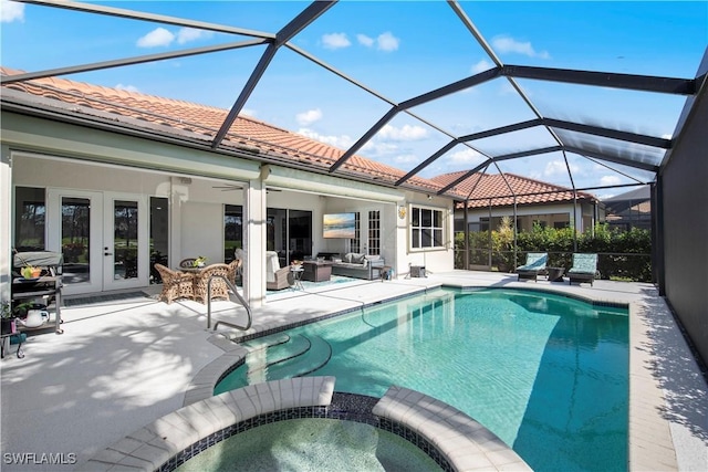 view of swimming pool with a lanai, outdoor lounge area, a patio area, french doors, and an in ground hot tub