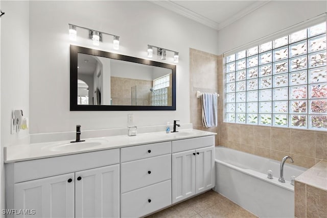 bathroom with tile patterned flooring, ornamental molding, a tub, and vanity