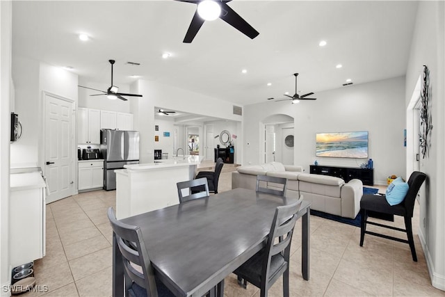 tiled dining room featuring sink and ceiling fan