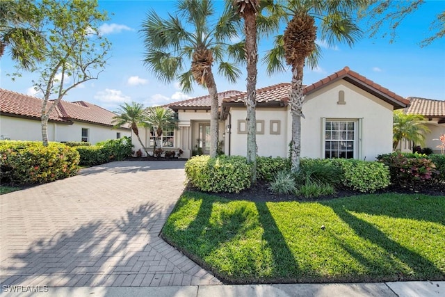 mediterranean / spanish-style house with a front yard