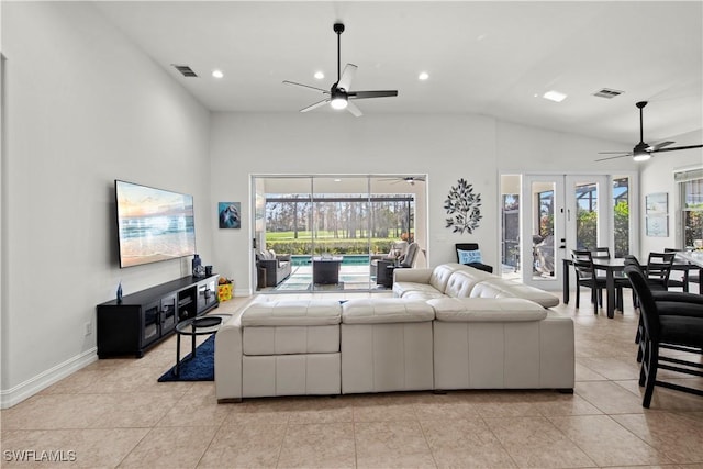 tiled living room with high vaulted ceiling, a healthy amount of sunlight, ceiling fan, and french doors