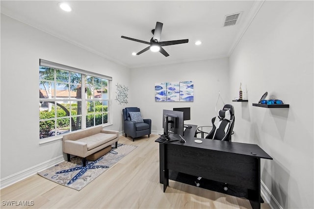 office space featuring ceiling fan, ornamental molding, and light hardwood / wood-style floors