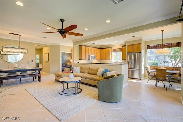 tiled living room featuring ceiling fan and ornamental molding