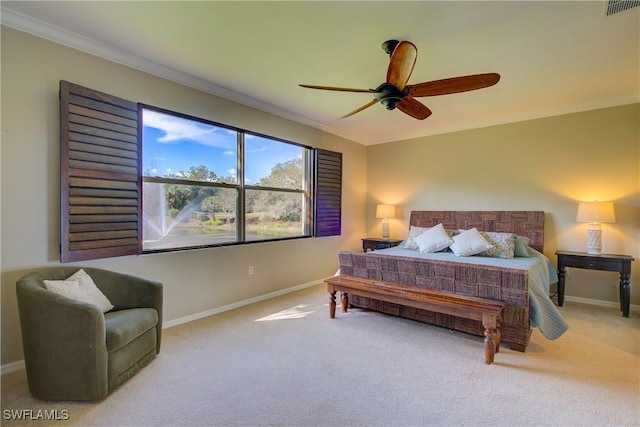 bedroom featuring ceiling fan, ornamental molding, and carpet