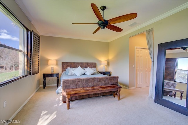 carpeted bedroom with ornamental molding and ceiling fan