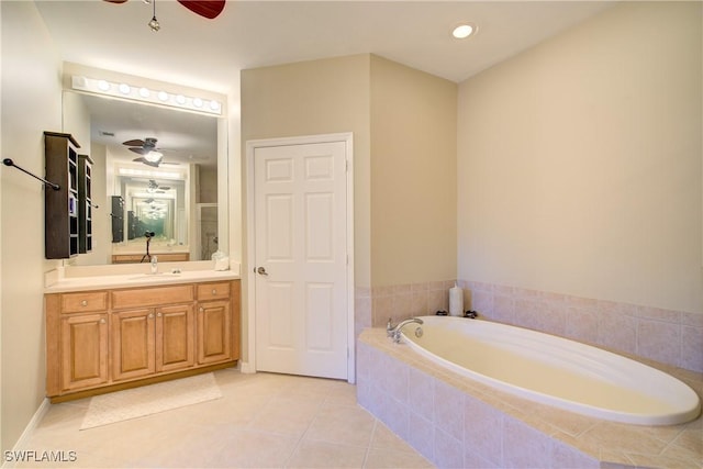 bathroom with ceiling fan, vanity, tiled bath, and tile patterned flooring