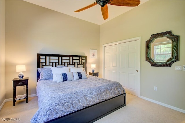 bedroom featuring ceiling fan, light colored carpet, and a closet