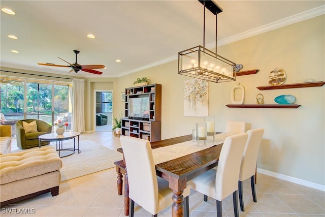 tiled dining area featuring crown molding and ceiling fan with notable chandelier