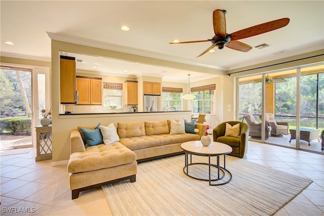 living room featuring light tile patterned flooring, ceiling fan, and ornamental molding