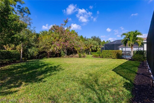 view of yard with a lanai