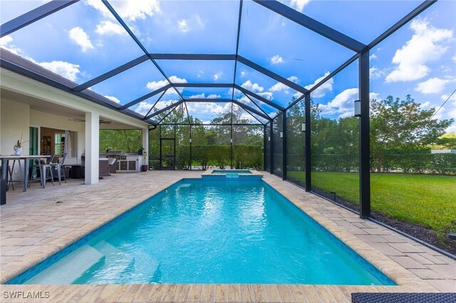 view of swimming pool with an in ground hot tub, ceiling fan, a lanai, and a patio