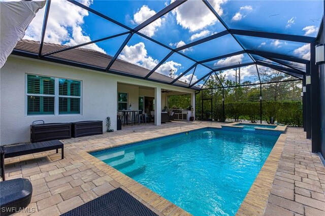 view of pool featuring an in ground hot tub, a lanai, and a patio area