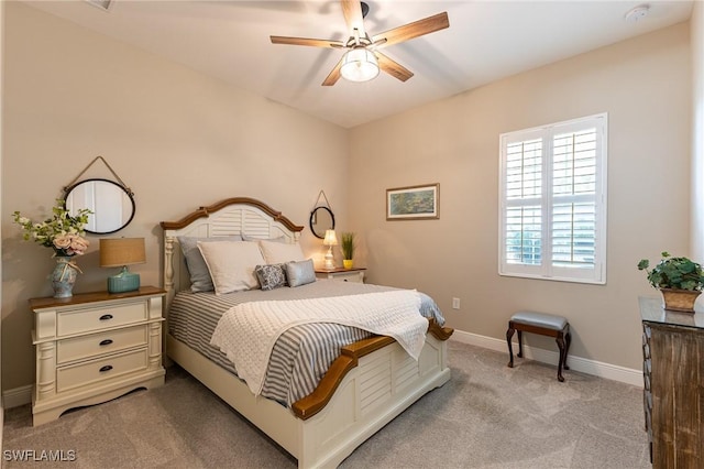 bedroom with light carpet, baseboards, and a ceiling fan