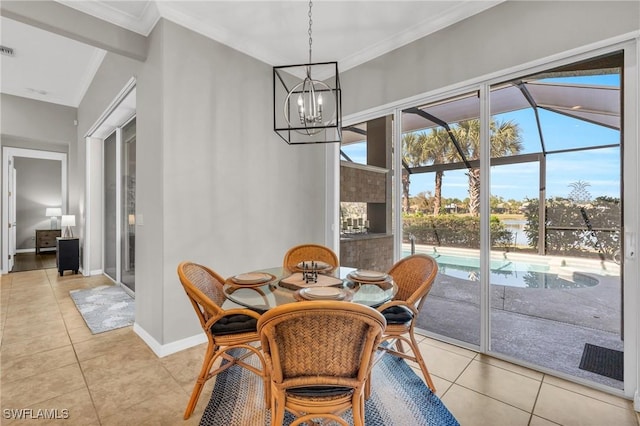 dining area featuring light tile patterned flooring, ornamental molding, and a notable chandelier