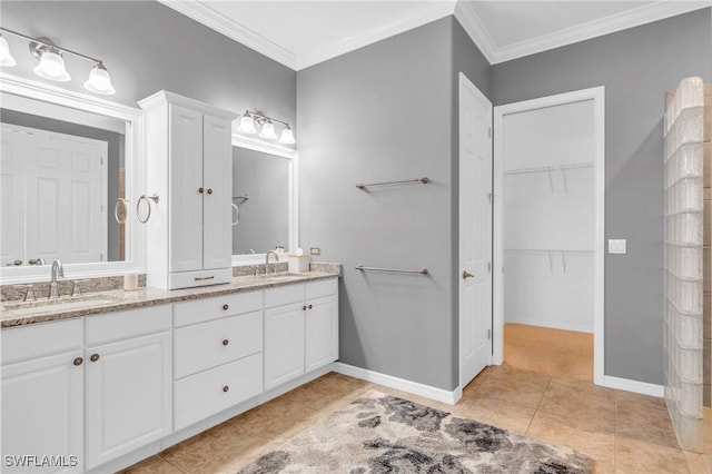 bathroom featuring tile patterned flooring, crown molding, and vanity