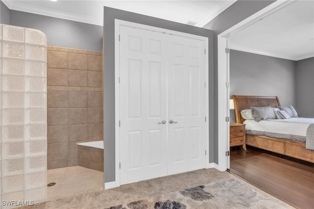 bedroom featuring crown molding and a closet