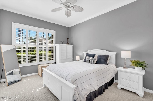 carpeted bedroom featuring ornamental molding and ceiling fan