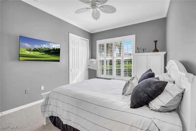 carpeted bedroom featuring crown molding, ceiling fan, and a closet