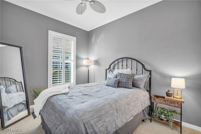 bedroom with crown molding, light carpet, and ceiling fan