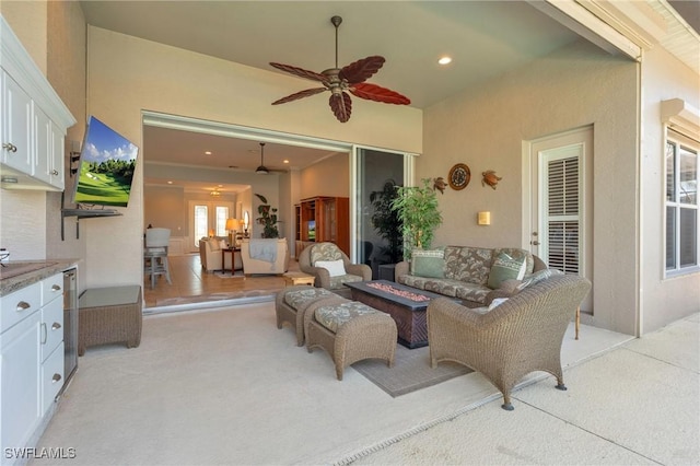 view of patio with an outdoor living space with a fire pit