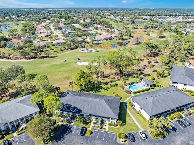 aerial view with view of golf course, a water view, and a residential view