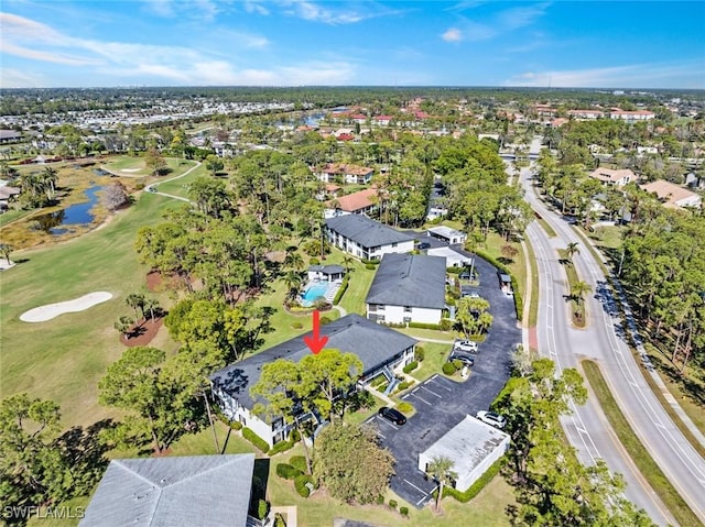 birds eye view of property featuring view of golf course and a residential view