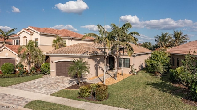 mediterranean / spanish house with a garage and a front lawn