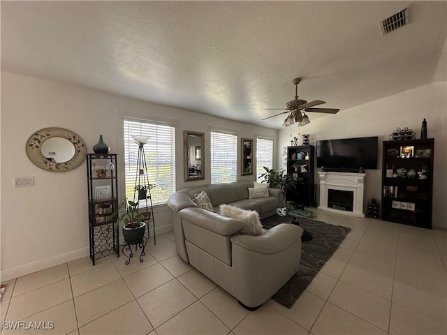 living room with light tile patterned floors and ceiling fan