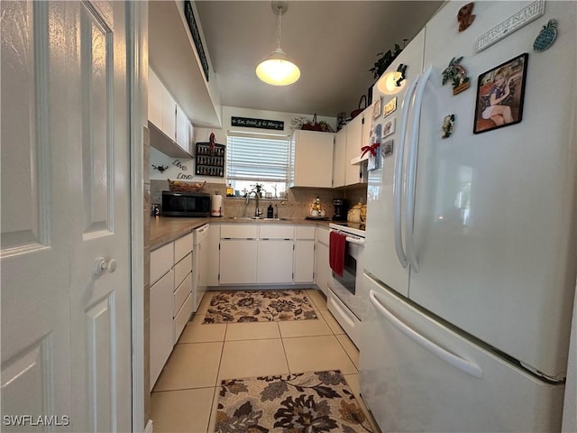 kitchen featuring white cabinetry, white appliances, decorative backsplash, and light tile patterned floors