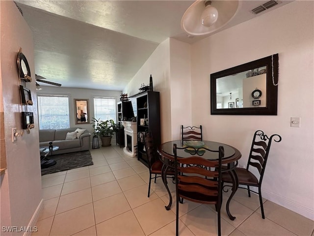 tiled dining space featuring ceiling fan