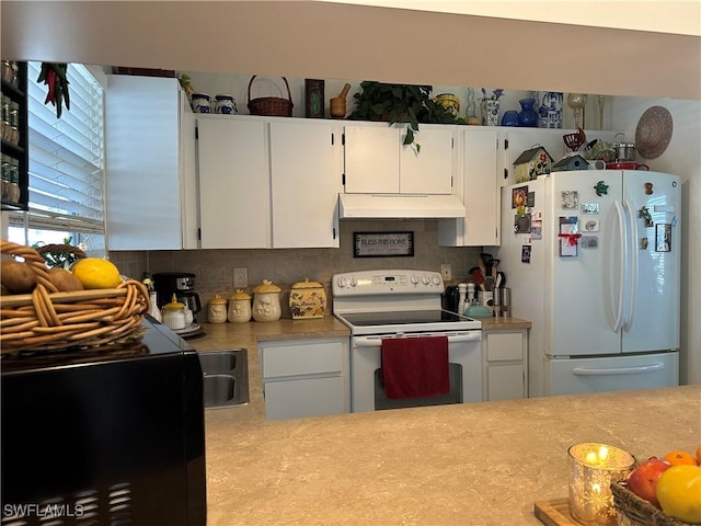 kitchen featuring white cabinetry, backsplash, and white appliances