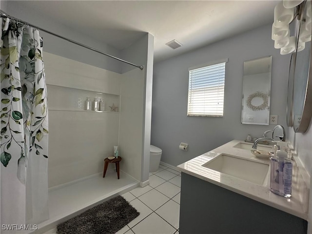 bathroom with a shower with shower curtain, vanity, toilet, and tile patterned flooring