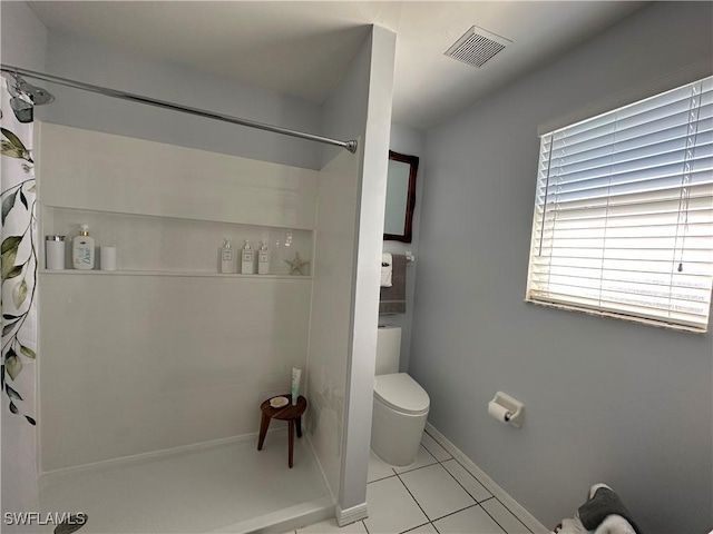 bathroom with toilet, tile patterned floors, and walk in shower