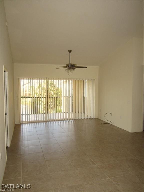 spare room with tile patterned flooring and ceiling fan