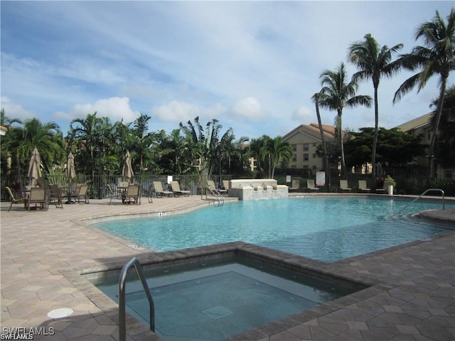 view of pool with a community hot tub and a patio area