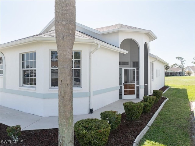 view of home's exterior featuring a yard and a patio