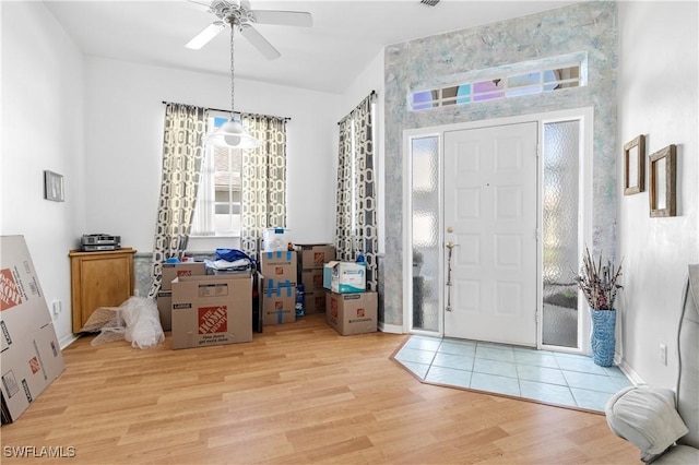 foyer with ceiling fan and light hardwood / wood-style floors