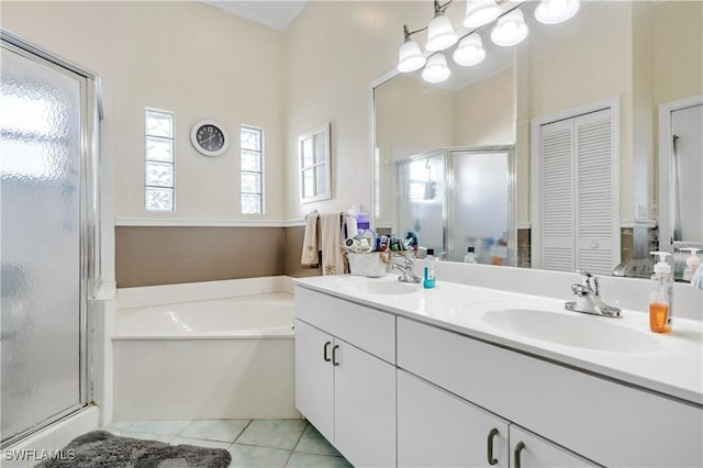 bathroom featuring tile patterned floors, independent shower and bath, and vanity