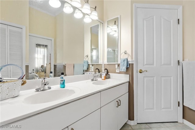 bathroom featuring vanity, tile patterned flooring, and an inviting chandelier