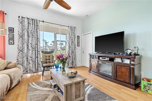 living room with ceiling fan and light hardwood / wood-style floors