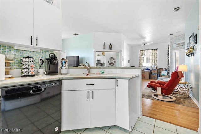 kitchen with sink, dishwasher, white cabinetry, light tile patterned flooring, and kitchen peninsula