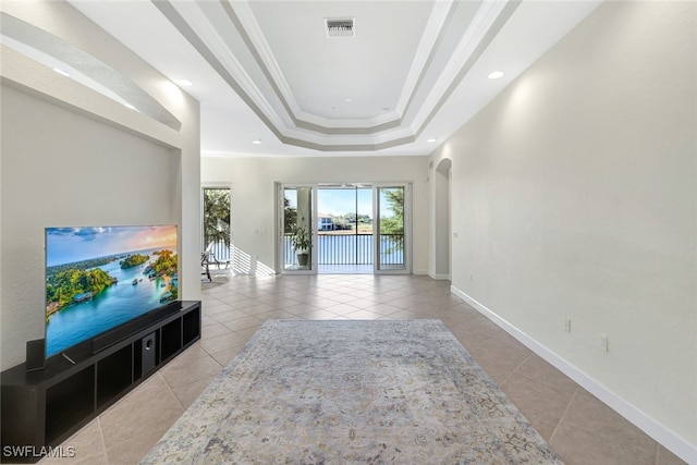 tiled living room featuring crown molding and a raised ceiling