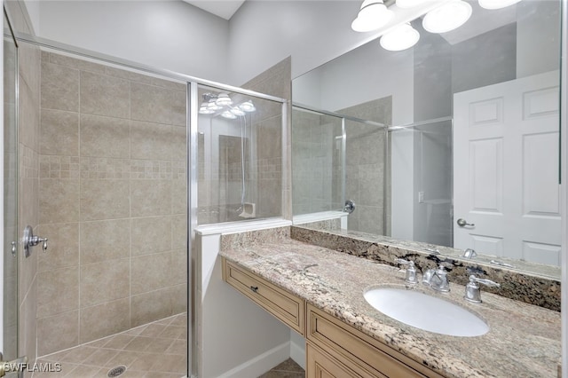 bathroom featuring walk in shower and vanity