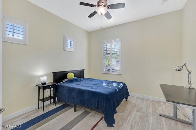 bedroom with ceiling fan and light wood-type flooring